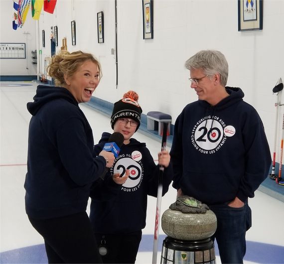 woman smiling with child and person curling